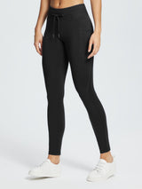 Black water-resistant 3/4 thermal ski leggings with a drawstring waist and pocket detail. #color_Black