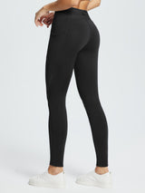 Black water-resistant 3/4 thermal ski leggings with side pocket and white sneakers. #color_Black