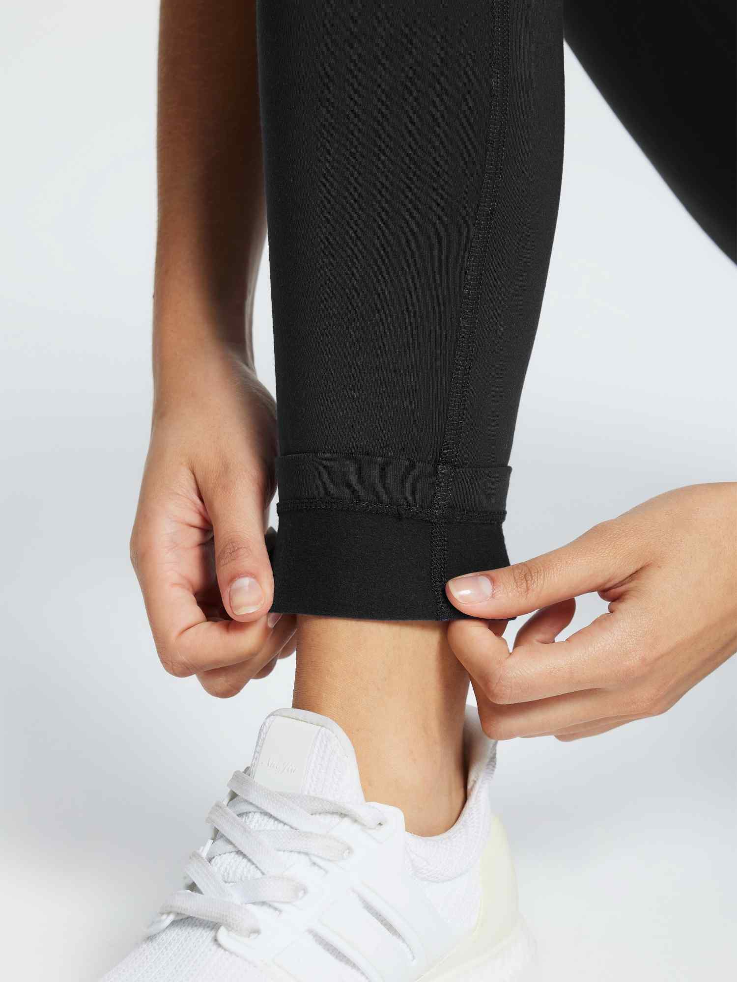 Black 3/4 thermal ski leggings showing fleece lining at the ankle. #color_Black