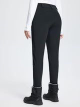 Black stretch knit slim-fit ski pants with fleece lining and reflective sleeve detail. #color_Black