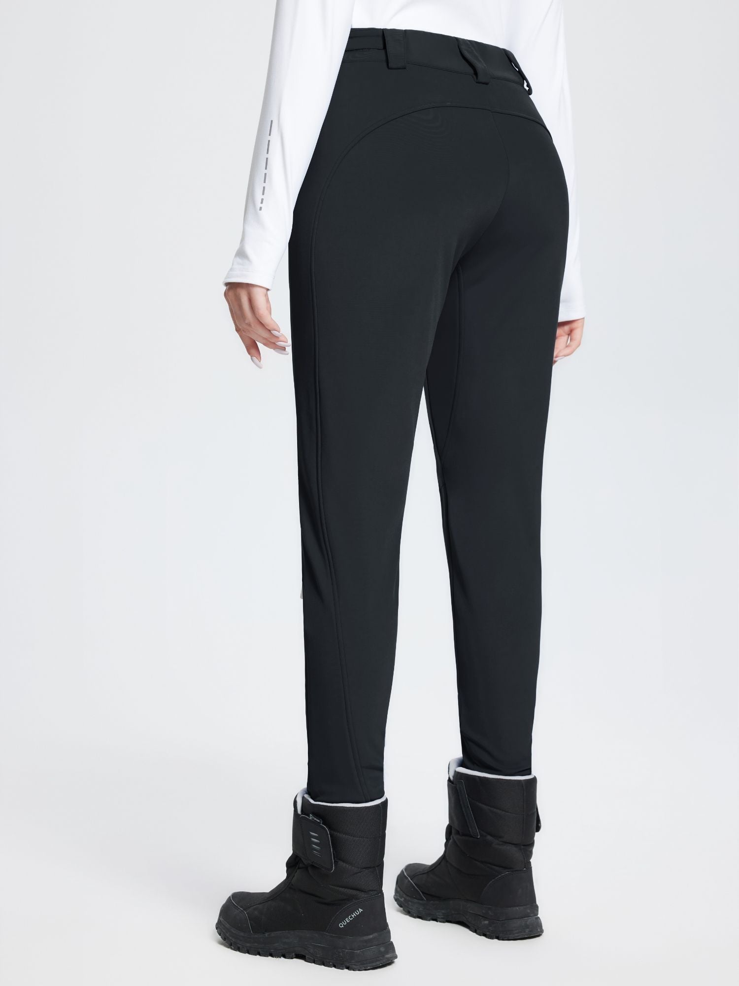 Black stretch knit slim-fit ski pants with fleece lining and reflective sleeve detail. #color_Black