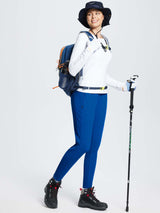 Woman in slim-fit ski pants, hiking gear, and backpack #color_Quartz Blue