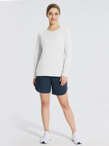Woman in white UPF 50+ long sleeve rash guard and navy shorts, ideal for outdoor activities.