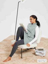 Light gray sleeveless fleece thermal dress with quarter-zip and pockets, worn over a white long-sleeve shirt and dark leggings.